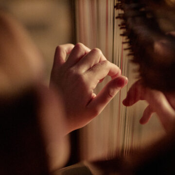 Hand of Professional Female Harpist Playing Music Plucking Strings of Instrument Indoors Μουσικοθεραπεία σε περιπτώσεις έντονης ανησυχίας