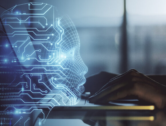 side-view-of-hands-using-laptop-with-glowing-circu-2026-01-11-08-34-25-utc Ποιος Καθορίζει το Μέλλον της Τεχνητής Νοημοσύνης;